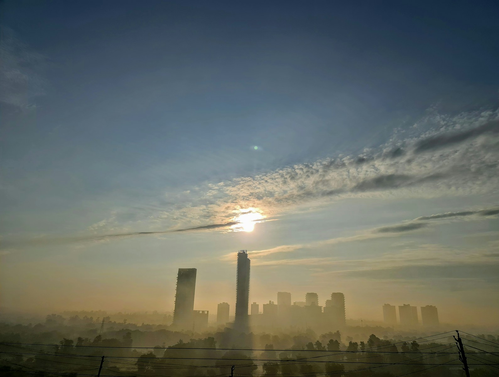 city skyline under blue sky and white clouds during daytime